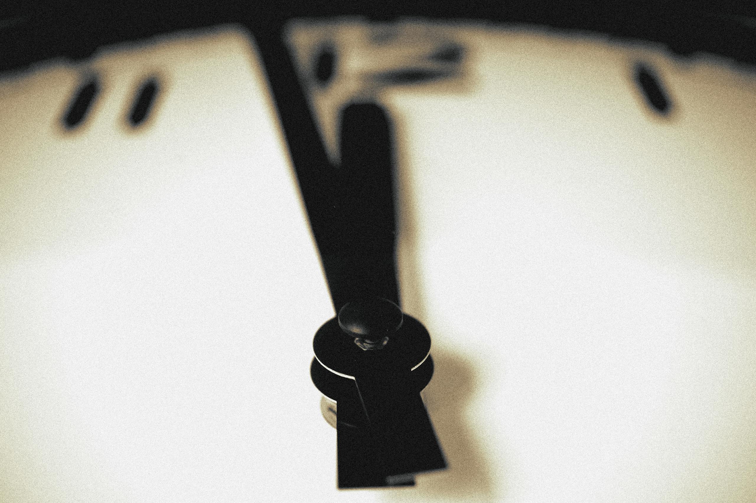 Artistic close-up of a blurred clock face emphasizing the passage of time.